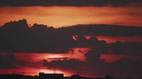 Big sun and a view of the rooftops of the city in real time Stock Footage 316537814