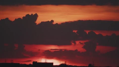 Big sun and a view of the rooftops of the city in real time Stock Footage 316537913