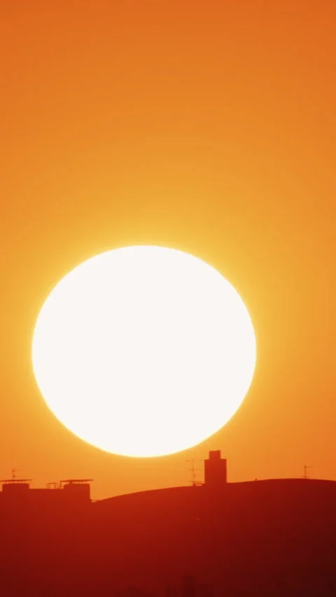 Big sun and a view of the rooftops of the city. Vertical. Timelapse Stock Footage 316967849
