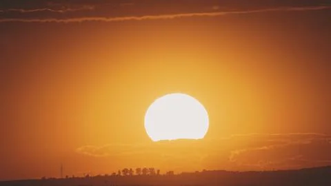 Big sun with clouds. Sunset Stock Photos