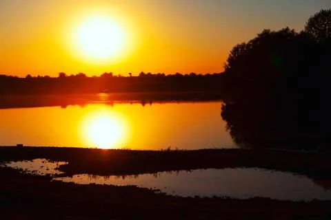 Big Sun reflection in the lake Stock Photos