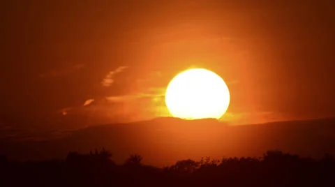 Big sun sunset time lapse with clouds over trees close 4K version Stock Footage