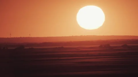 Big sun at sunset with wind turbines Stock Footage 243027685