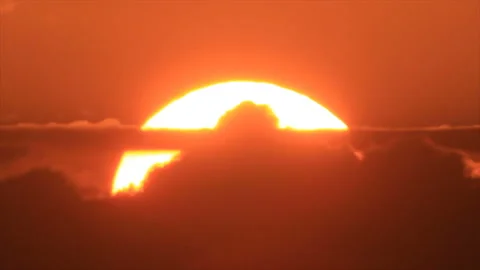 Big sunset sun disappearing in clouds Stock Footage 155414305