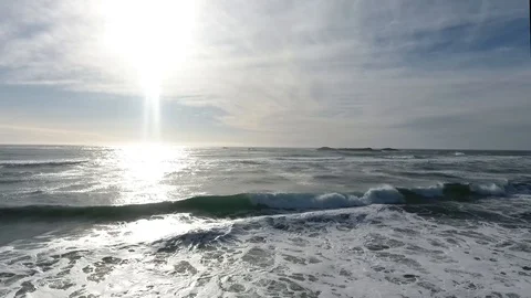 Big surf waves rolling in on sunny day Stockbeeldmateriaal 90680237