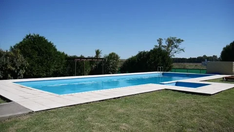 Big swimming pool without people, blue, wind and sunny day. Stock Footage 154309680