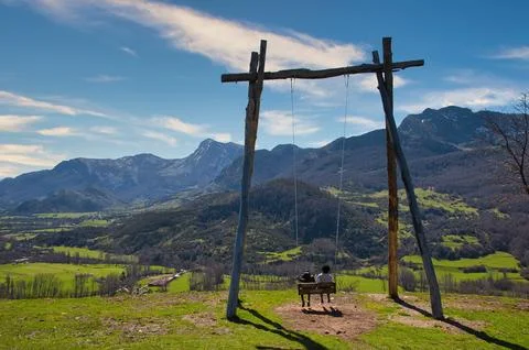 A big swing in pico Caleo, viewpoint over Lario village, Montaa de Riao y Mam Stock Photos