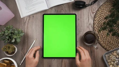 Big tab with chroma key screen on it. Hand swipe left on touchscreen. Top view. Stock Footage 129389497