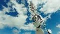 big tall communication tower with blue sky and clouds background HD Footage