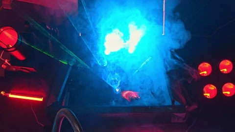 A big technological military machine covered in smoke and neon lights - lazer Stock Footage 116186935