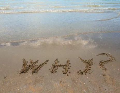 Big text why on the sandy beach by the sea Stock Photos