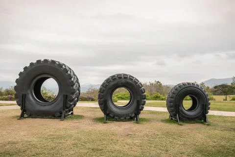 Big tires in three size on grass floor Stock Photos