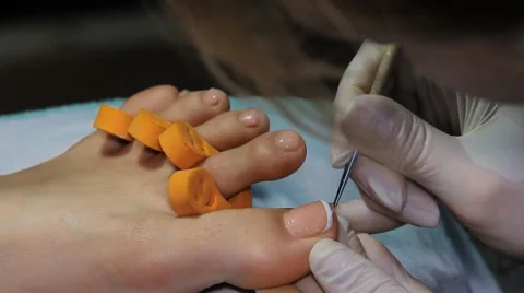 The big toe of the left foot to paint varnish Stock Footage 64570151