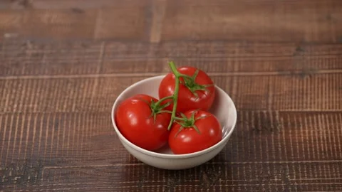 Big tomatoes on the plate Stock Footage 183496736