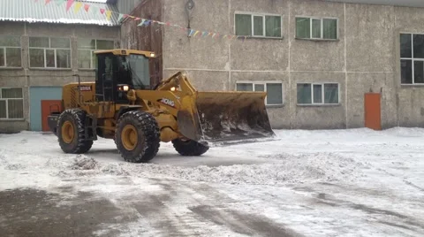 Big tractor clears snow and ice Stock Footage 56639158