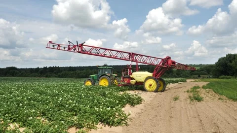 Big tractor with irrigation plant is preparing to water the potatoes in field Stock Footage 245842182