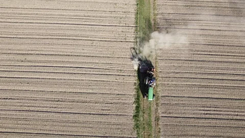 Big tractor with mowers mows the grass for silage farmer works in the meadows Stock Footage 154182870