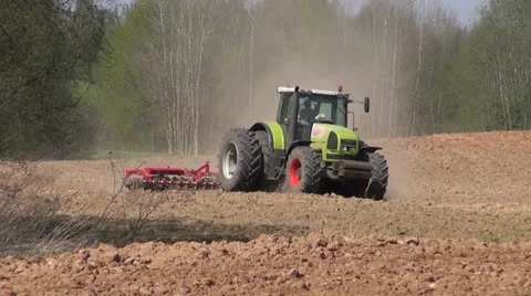 Big tractor plowed early spring farm field Video stock 23409939