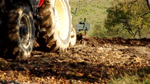 Big tractor plowing land in fall Stock Footage 57300467