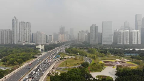 Big traffic jam on the freeway. In the background is a metropolis Stock Footage 118472220