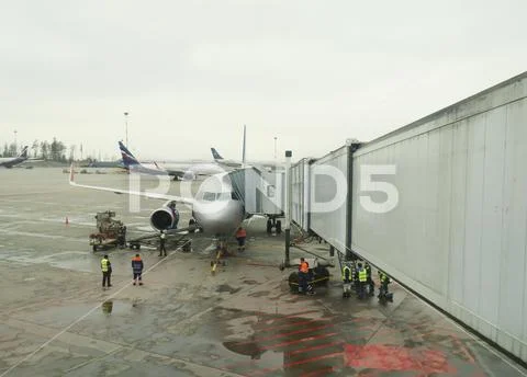 Big traffic of passengers airliners and service cars ride at airdrome Stock Photos
