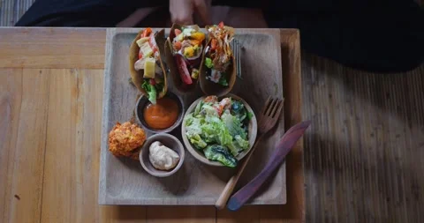 Big tray of three raw vegan tacos with sour cream, broccoli and salad Stock Footage 282971609
