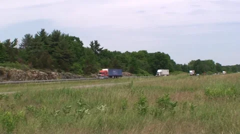 Big trucks and traffic driving down a highway. Stock Footage 48353953