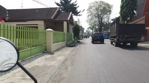 Big trucks overtake small vehicles on narrow streets Stock Footage 199760325