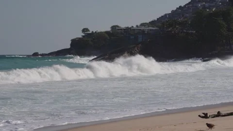 Big turquoise waves roll onto the rocky coast of Leblon Beach in Rio de Janeiro. Stock Footage 301088538