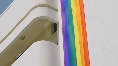 Big vertical Gay Pride flag is hanging on a building in Tel Aviv, Israel Stock Footage 110628407