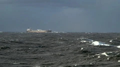 Big vessel in storm. Waves with white foam. Sun illuminates ship and waves Stock Footage 270780512