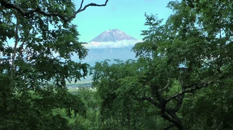 Big volcano and small people Stock Footage 8557680