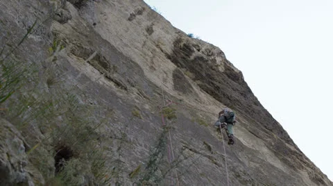 Big wall climber jumars up fixed rope Stock Footage 25915574