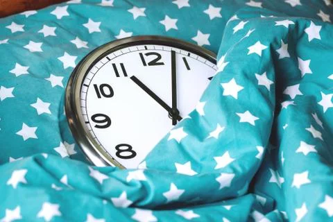 Big wall clock in a blue bed Stock Photos