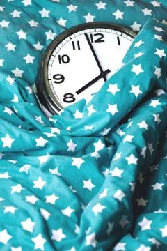 Big wall clock in a blue bed Stock Photos