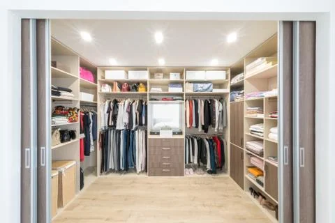 Big wardrobe with different clothes for dressing room Stock Photos