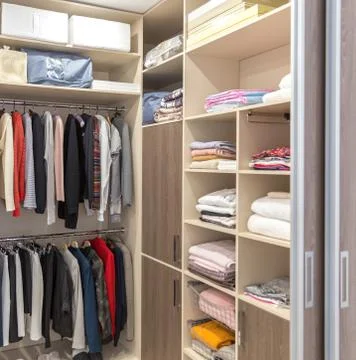 Big wardrobe with different clothes for dressing room Stock Photos