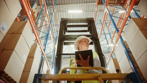 Big Warehouse Female Worker Uses Digital Tablet Computer while Stock Footage 141577588
