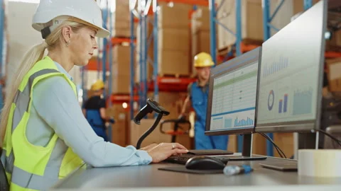 Big Warehouse Worker uses Personal Computer with Spreadsheets Stock Footage 141575289