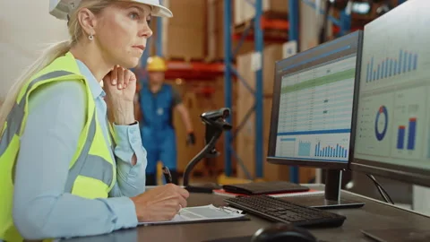 Big Warehouse Worker uses Personal Computer with Spreadsheets Stock Footage 141575329
