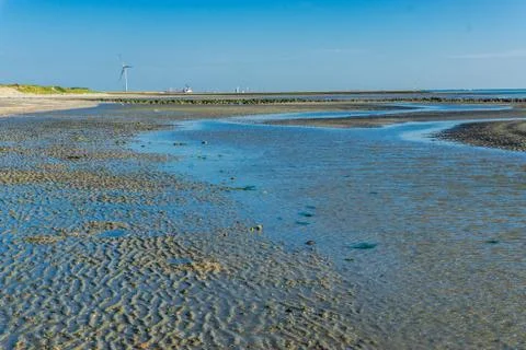 Big water puddle that split of the ocean Stock Photos