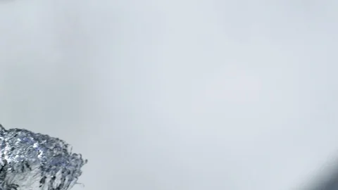 Big water splash with blue reflections in front of white background in slowmo Video stock 98700893