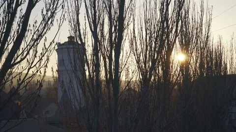 Big water tower behind the trees at sunset Stock Footage 105278336