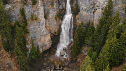 Big waterfall in the mountains. Flying between trees over green mountain forest Stock-Footage 150664532
