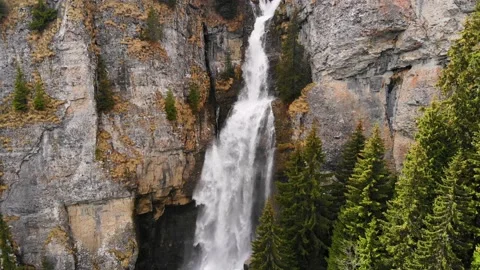 Big waterfall in the mountains. Flying between trees over green mountain forest 스톡 동영상 150664637
