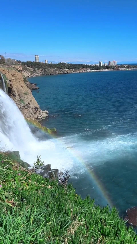 Big Waterfall splashes water rainbow city sea cliff rock 動画素材 274052525