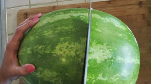 A big Watermelon being cut by a big knife Stock Footage 45281152