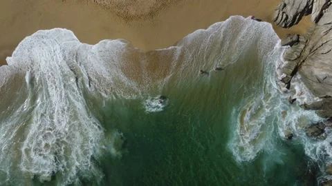 Big wave breaking over a sandy beach and turquoise sea Stock Footage 330833386