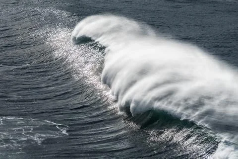 Big wave breaking with spray Stock Photos