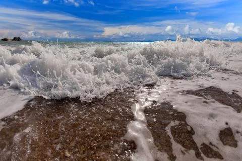 Big wave front with bubbles and splashes Stock Photos